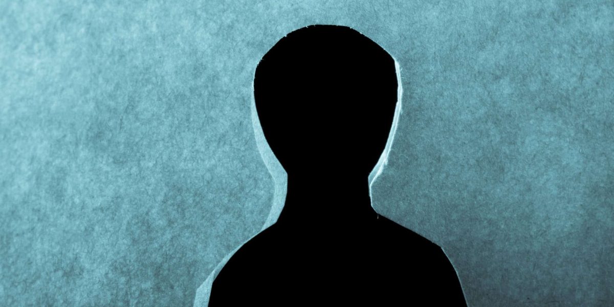 Man shape cut out of paper in hand in the view