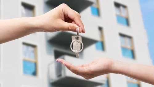Pareja firmando una extinción de condominio con hipoteca para que uno de los propietarios se quede la vivienda y asuma el préstamo hipotecario